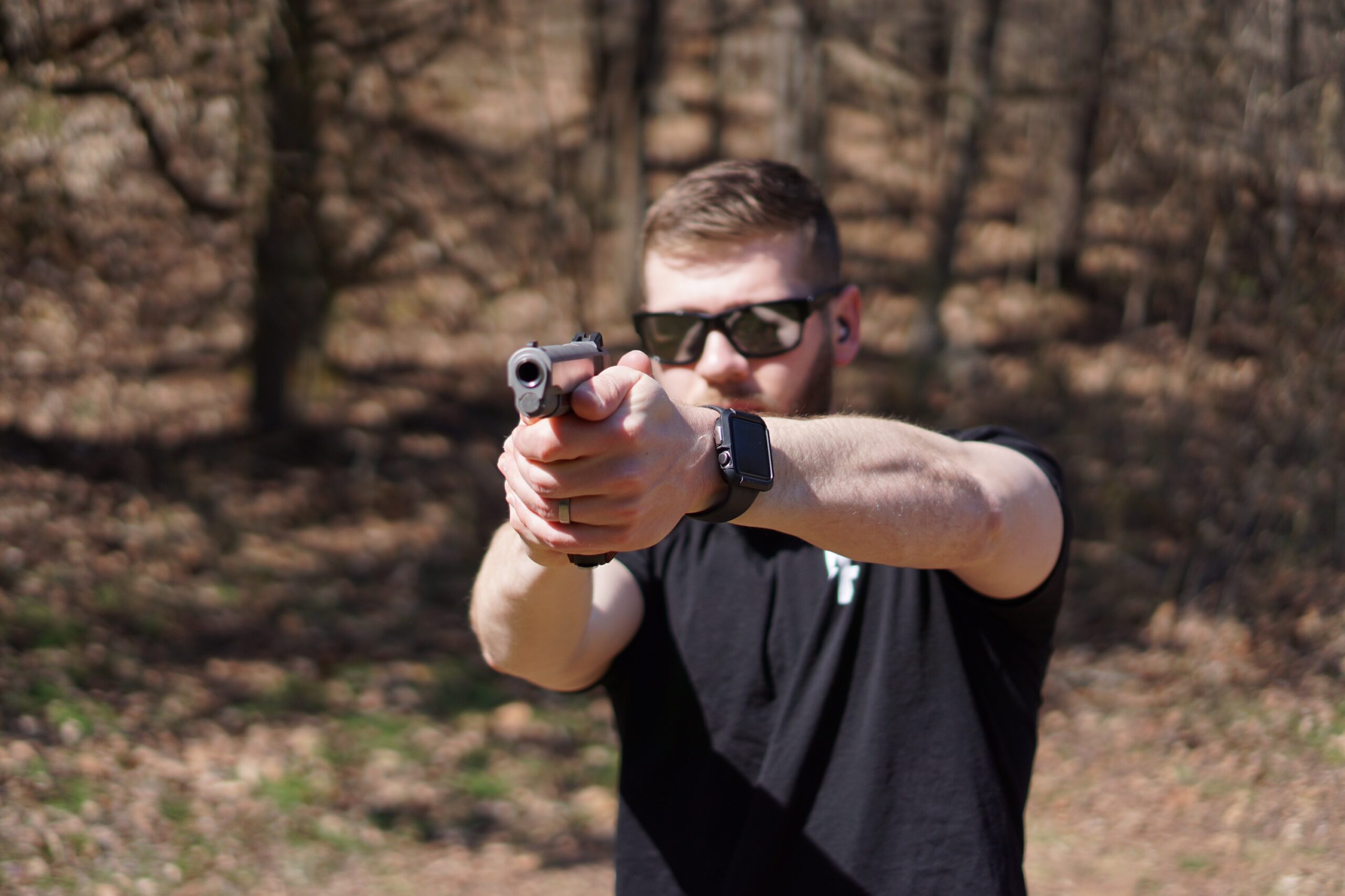 The Author firing a Dan Wesson 1911 Classic pistol at a shooting range